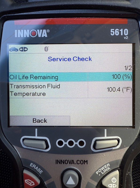 Innova 5610 scan tool connected to a car dashboard during a diagnostic workflow