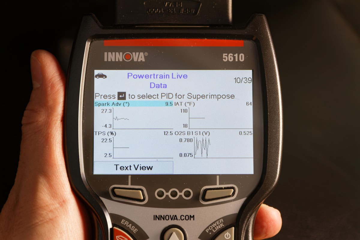 Innova 5610 scan tool connected to a vehicle battery and electrical system for safety testing
