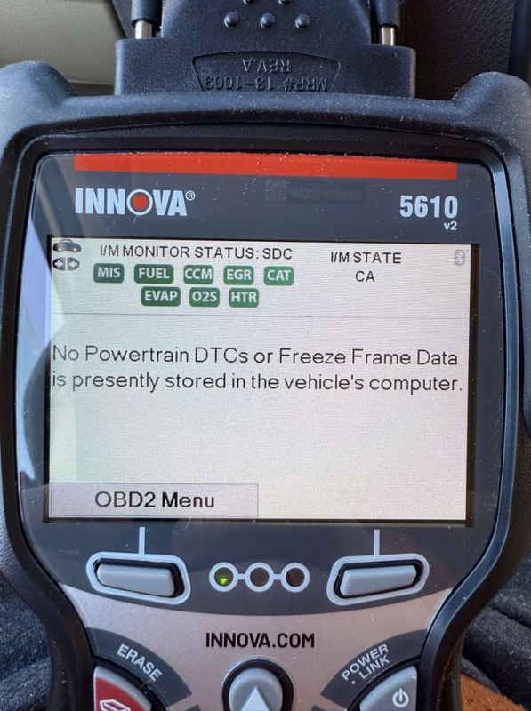 Innova 5610 scanner connected to a car OBD2 port during setup