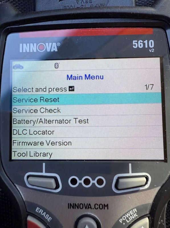 Person downloading and installing an Innova 5610 OBD2 update on a laptop