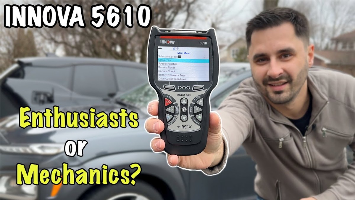 Person using an Innova 5610 V3 OBD2 scanner near a car’s dashboard diagnostic port
