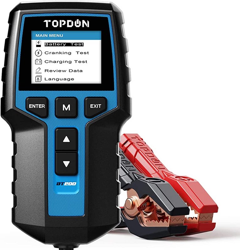 Technician using a battery tester near a car battery, illustrating safety and warranty risk factors