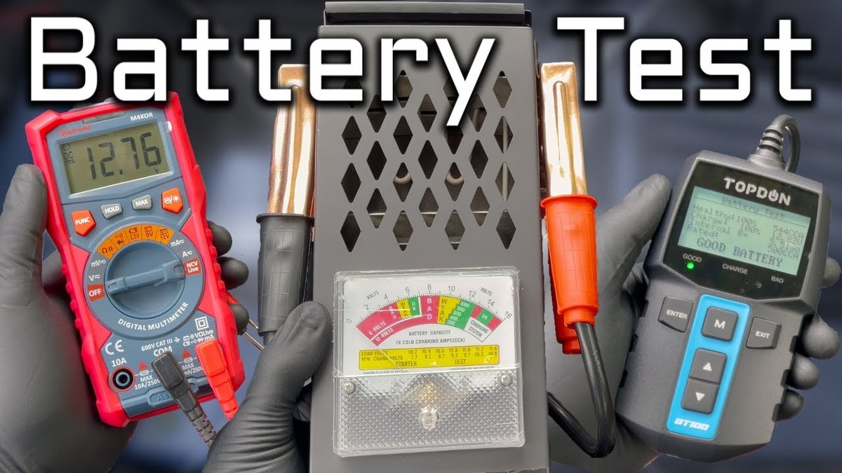 Person using a multimeter to test a car battery while checking battery terminals under the hood