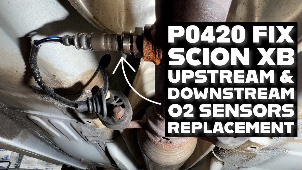 Mechanic inspecting catalytic converter and oxygen sensor on a vehicle lift